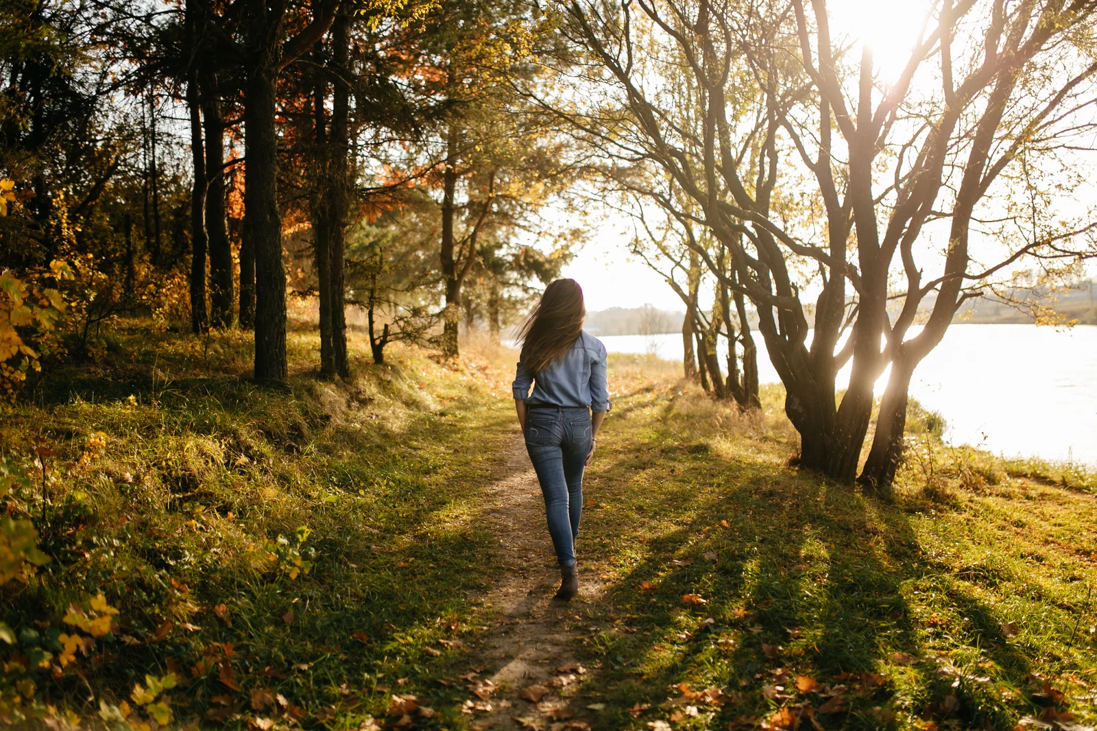 Young couple walking in the autumn forest park