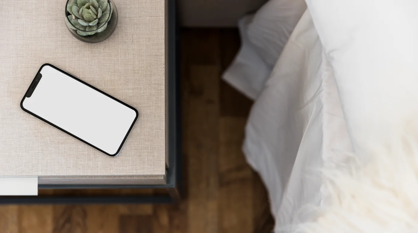 Minimalist desk setup with iPhone in horizontal StandBy mode displaying an elegant warm-toned countdown timer