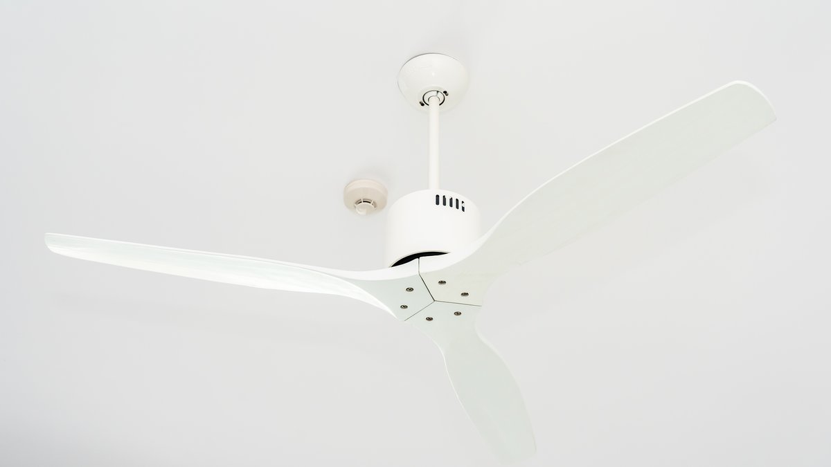 Modern ceiling fan with integrated lighting fixture mounted on bedroom ceiling