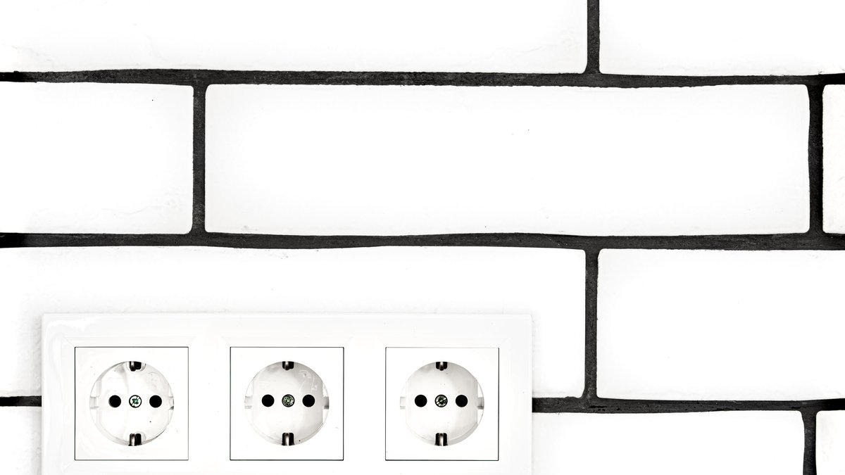 Close-up of modern electrical wall power outlets and switch plate under counter-surveillance inspection