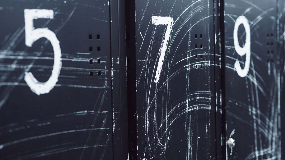 Inspection of modern gym locker room rows and numbered changing lockers for concealed surveillance devices