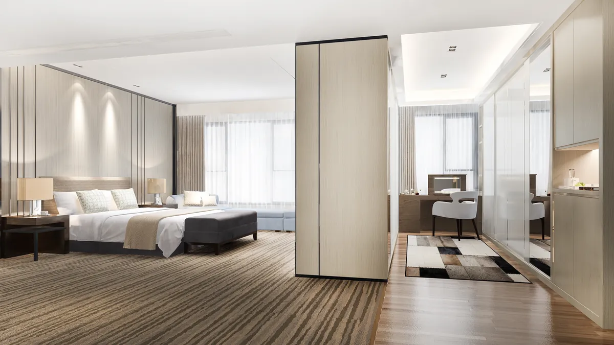 Spacious modern hotel bedroom with clean interior decor and natural lighting