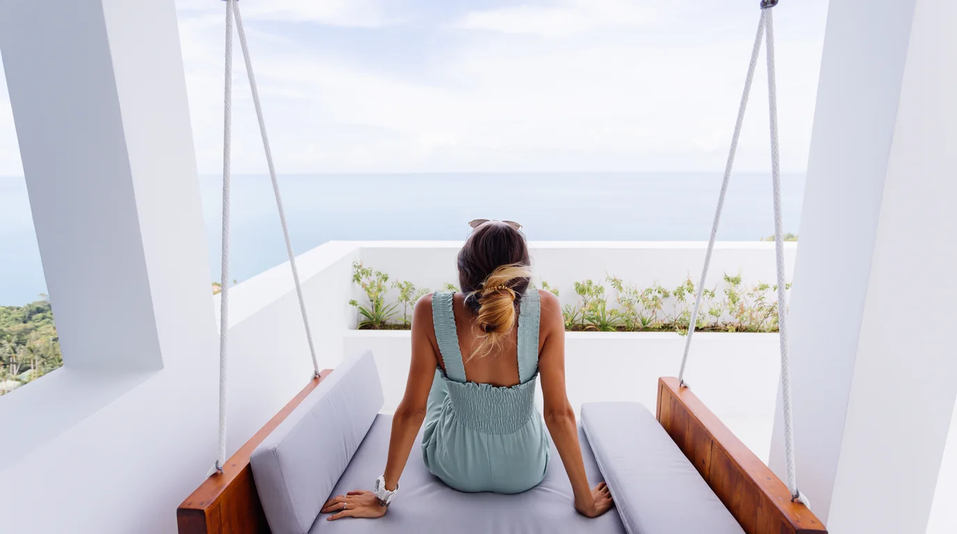 Cruise ship stateroom cabin interior overlooking private ocean balcony