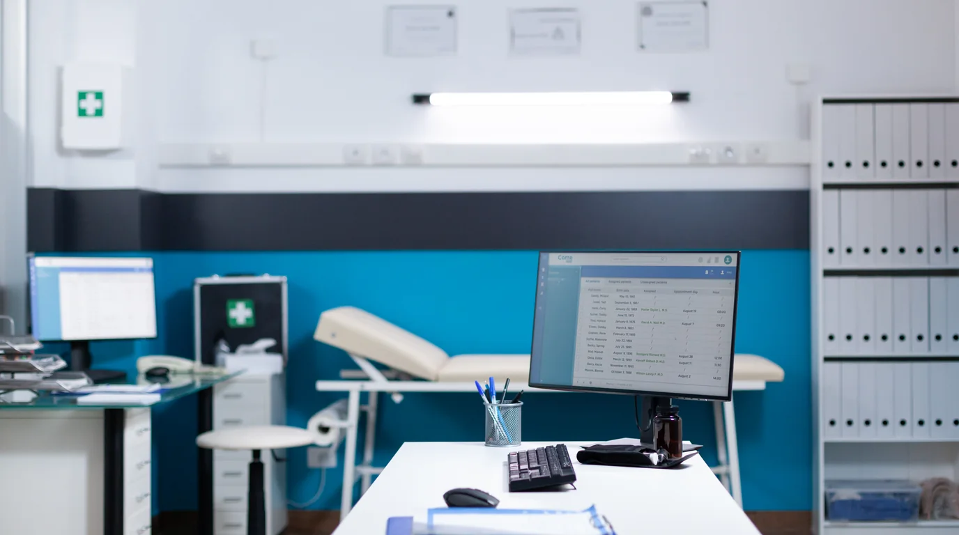 Modern clinic examination room featuring patient exam table and medical equipment