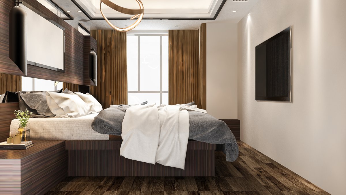Modern luxury hotel bedroom suite with large wall-mounted smart TV and media console under inspection