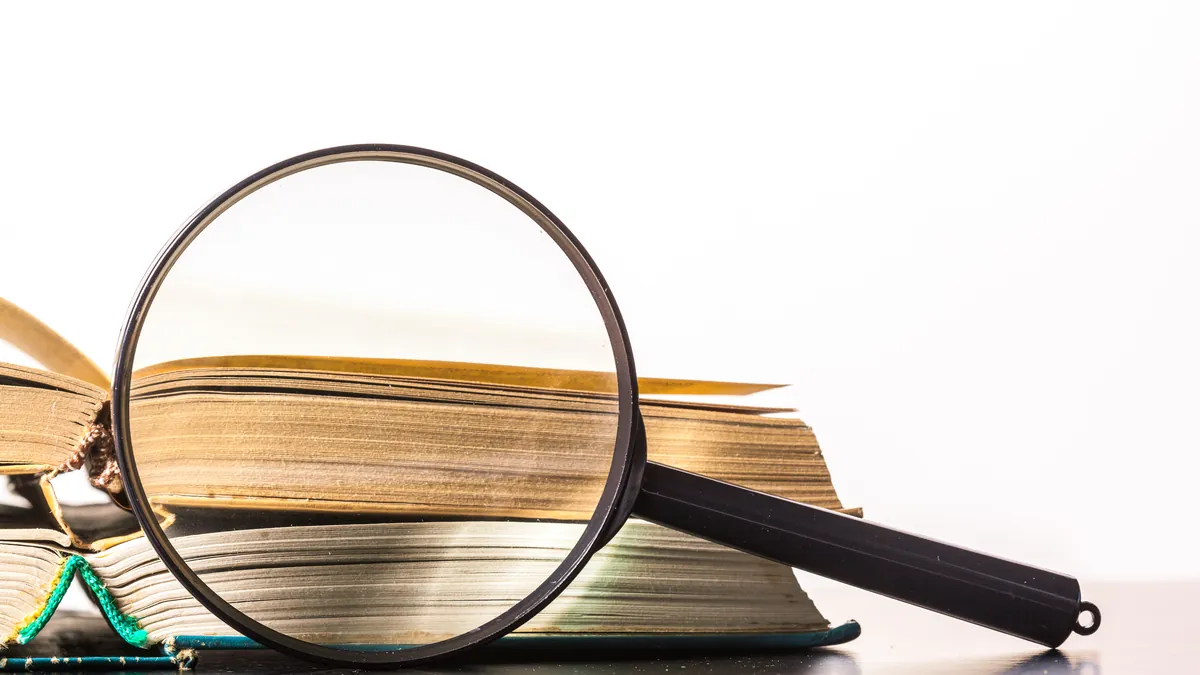 Investigative legal paperwork on desk with magnifying glass and documentation notes