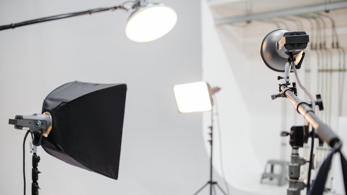 Professional photography studio with studio lights, backdrop, and changing area under security inspection