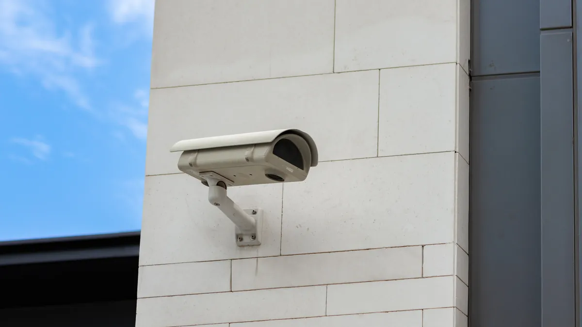Modern security surveillance dome camera mounted on wall corner