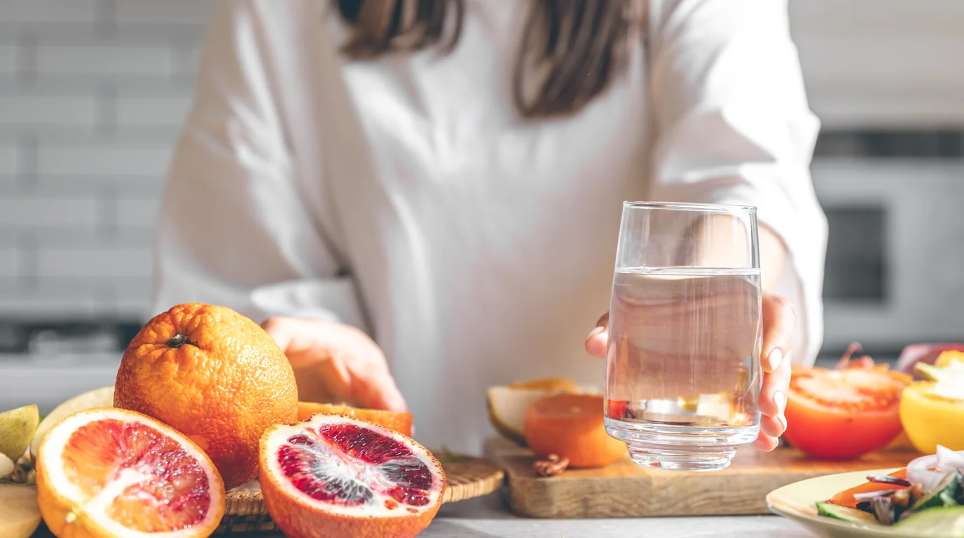 Morning wellness routine with a clean glass of water and natural herbal adaptogen supplements